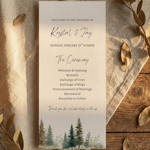 May include: A wedding program with the names "Krystal & Jay" in elegant script. The program details the ceremony schedule, including the welcome, vows, and reception. The bottom features a watercolor forest design.