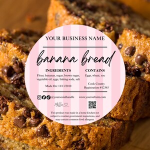 May include: Slices of banana bread with chocolate chips, with a pink label that reads "banana bread" and lists ingredients and business information. The bread is on a wooden surface.