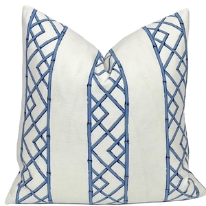 May include: White pillow with a blue and white trellis pattern. The pattern features a repeating design of vertical lines and a trellis pattern.