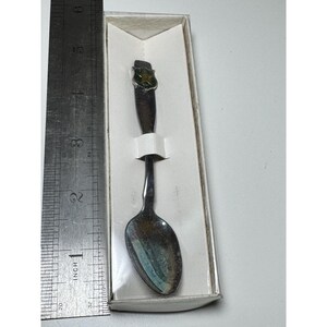 May include: A white ceramic mug with a black handle and the text "But First, Coffee" in a bold, black font. The mug is set against a blurred background, suggesting a cozy setting. The mug appears to be approximately 4 inches tall.