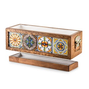 May include: A rectangular wooden planter with a white interior and a separate tray. The front of the planter features four colorful ceramic tiles with floral and geometric designs. A metal clasp is on the side.