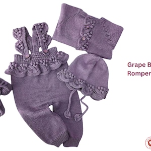 May include: A grape-colored baby romper set, including a romper with suspenders, a cardigan, a hat, and booties. The set is knit with decorative edging and bobble details. The text "Grape Baby Romper Set" is visible.