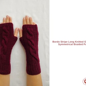 May include: A pair of burgundy knitted gauntlets with a braided cable pattern. The text "Bordo Stripe Long Knitted Gauntlets - Symmetrical Braided Pattern" is visible. The gauntlets are displayed on a white background.