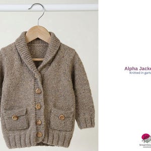 May include: A white ceramic mug with a black handle and the text "But First, Coffee" in a black, handwritten-style font. The mug is on a white surface.