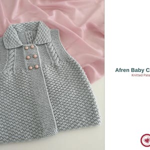 May include: A grey knitted baby cardigan with a collar and pink buttons. The sleeveless sweater features a textured stitch pattern and cable knit detailing on the shoulders. The text "Afren Baby Cardigan Knitted Pattern" is visible.