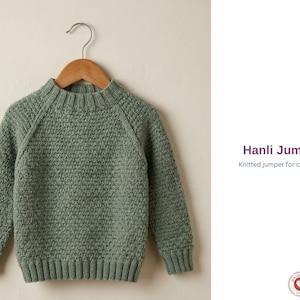 May include: A sage green knitted jumper for children, displayed on a wooden hanger. The jumper features a textured stitch, ribbed cuffs, and a ribbed hem. The text "Hanli Jumper" and "Knitted jumper for children" are visible.