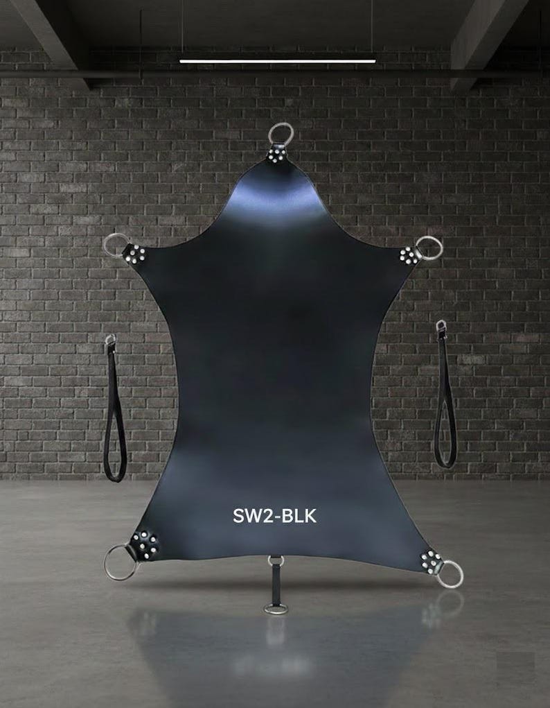 Black leather suspension sling with multiple attachment points. Features metal rings and straps for support. The text "SW2-BLK" is visible on the sling.