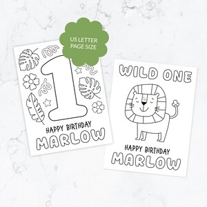 May include: Two white coloring pages with black outlines. One page features a large number 1, tropical leaves, flowers, and the text HAPPY BIRTHDAY MARLOW. The other page shows a lion, the text WILD ONE, and HAPPY BIRTHDAY MARLOW. US LETTER PAGE SIZE.
