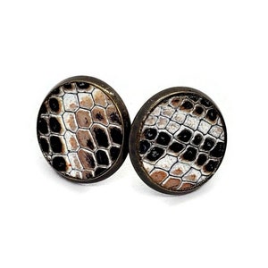 May include: A pair of round, bronze-colored earrings with a white and black snake skin pattern.