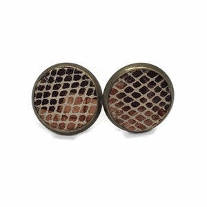 May include: A pair of round, bronze-colored earrings with a snakeskin pattern. The pattern is a light brown and dark brown color.