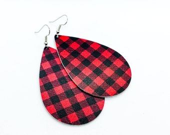 May include: A pair of red and black plaid teardrop-shaped earrings with silver hooks.
