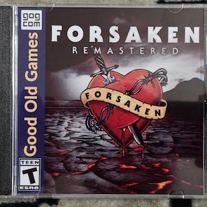 May include: A CD case for the video game "Forsaken Remastered." The cover art features a red heart pierced by a dagger and wrapped in barbed wire, with the word "Forsaken" on a banner. The case has a "Good Old Games" label.