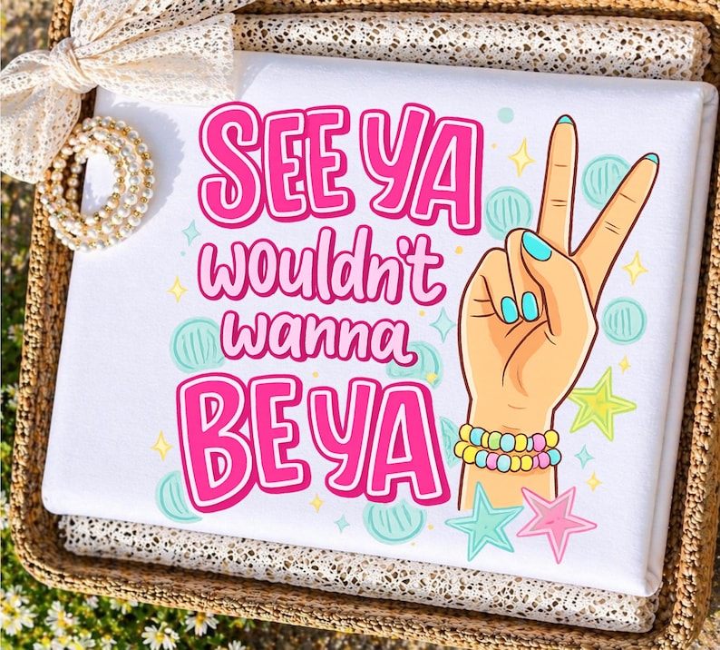 May include: White folded fabric with the text "SEE YA wouldn't wanna BE YA" in pink. A cartoon hand with blue fingernails makes a peace sign. The hand has a bracelet with yellow, pink, and blue beads. There are star and circle graphics.
