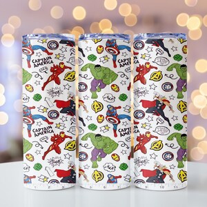 May include: Three white insulated tumblers featuring a repeating pattern of Marvel comic book characters. The design includes Captain America, Iron Man, Hulk, and Thor, along with comic book speech bubbles and stars.