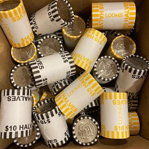 May include: A collection of paper rolls filled with silver half dollar coins. The rolls are labeled "$10 HALVES" and "LOOMIS" in black and yellow. Some coins are visible, showing the profile of a person.