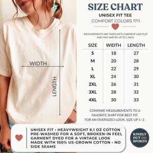 May include: A cream-colored unisex t-shirt shown with a size chart. The chart lists sizes S through 4XL with corresponding width and length measurements in inches. Text includes Comfort Colors 1711, 6.1 oz cotton, and vintage look details.