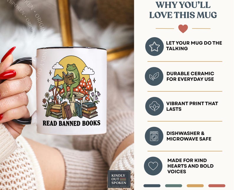 May include: White ceramic mug with a black handle and rim, featuring a whimsical design. The design includes a frog reading a book, mushrooms, and the text "READ BANNED BOOKS". The mug also has the text "WHY YOU'LL LOVE THIS MUG".