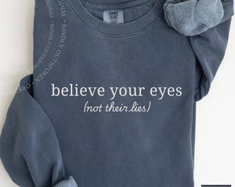 Sudadera de justicia social: "Cree en tus ojos, no en sus mentiras". Camiseta sutil.