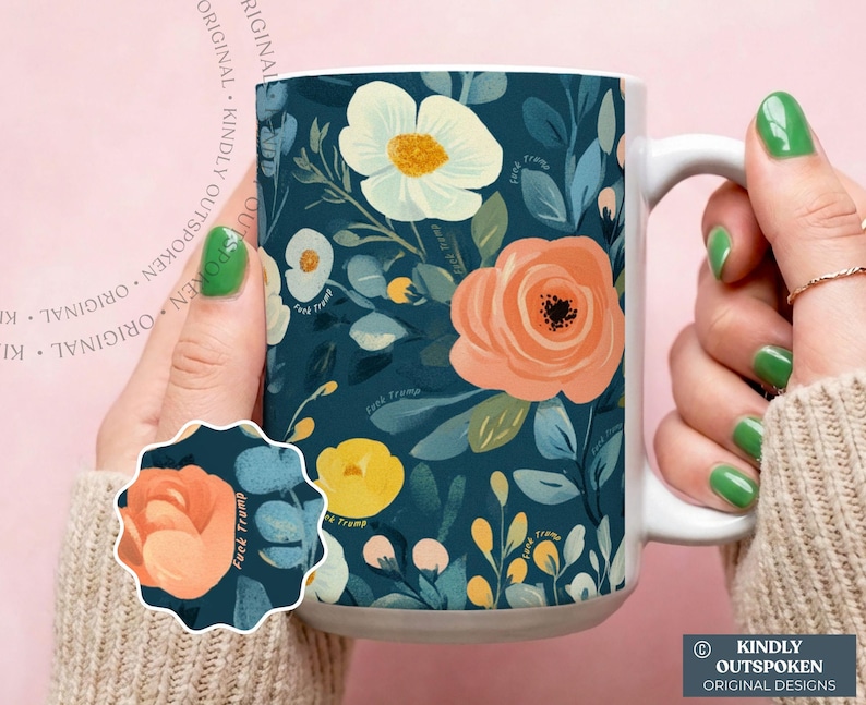 May include: A white ceramic mug featuring a dark teal background with a floral pattern of white, peach, and yellow flowers and green leaves. The text "fuck trump" is repeated in small, subtle script throughout the floral design.