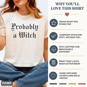 May include: An ivory t-shirt with the black text "Probably a Witch" in a gothic font. The right side features a list of product details including "Wear what you stand for," "Garment-dyed for soft, vintage feel," "100% cotton," and "Print that lasts."
