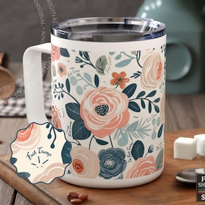 May include: A white travel mug with a clear lid featuring a floral pattern of pink, peach, and dark blue flowers and leaves. The text "Fuck Trump" is printed repeatedly in a small script font throughout the floral design and on a scalloped sticker.