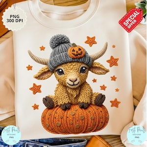 Op de afbeelding: Crèmekleurige sweatshirt met een grillige illustratie van een geit met een grijze gebreide muts met een pompoen en zittend op een oranje pompoen. Het ontwerp bevat oranje steraccenten, perfect voor Halloween.