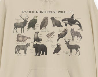 Moletom com capuz estilo anos 90 com estampa da vida selvagem do Noroeste do Pacífico: alce, águia-careca, orca, puma, veado, urso, marmota, coruja, coiote. Cores claras.