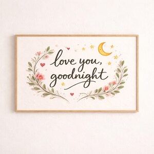 May include: A framed print with the words "love you, goodnight" in elegant script. The text is surrounded by a floral wreath with pink flowers, green leaves, and small red hearts. A yellow crescent moon and stars are also included.
