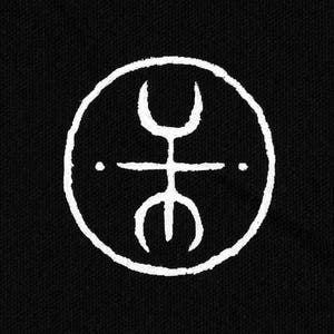 May include: A white, hand-drawn symbol within a circle, set against a black background. The symbol features a central horizontal line with two dots and vertical lines at the top and bottom, resembling a stylized figure. The design has a textured, slightly imperfect appearance.