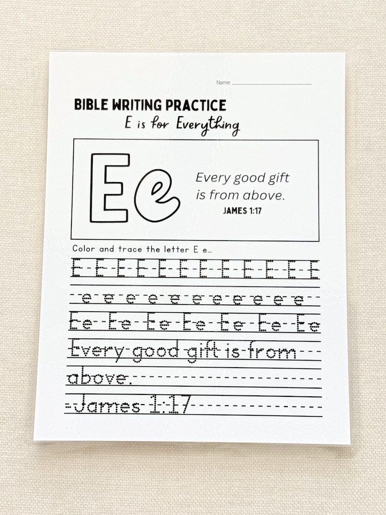 May include: A white Bible writing practice sheet with the text "BIBLE WRITING PRACTICE E is for Everything." The sheet includes the letters "E e" and the phrase "Every good gift is from above." Lines are provided for tracing the letters.