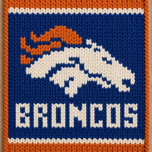 May include: A rectangular knitted wall hanging featuring the Denver Broncos logo in white and orange on a blue background. The design includes the word BRONCOS in white block letters below the horse head emblem, all bordered by a thick orange rope trim.
