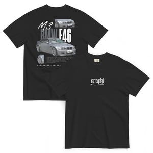 May include: Black t-shirt featuring a graphic of a silver BMW M3 E46 car on the front, with the text "M3 BMW E46". The back of the shirt has the word "graphi" in white script.
