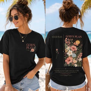May include: A black short-sleeve t-shirt featuring a small floral graphic and the text "GOD'S PLAN" on the front. The back displays a large floral arrangement, a sun icon, and the text "YOUR PLAN" and "GOD'S PLAN" with "ISAIAH 55:8-9".