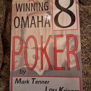 May include: A paperback book titled Winning Omaha 8 Poker by Mark Tenner and Lou Krieger. The cover features a large black number 8, red text, and a background image of stacked US dollar bills with a red star icon near the top left corner.