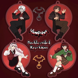 Pode incluir: Chaveiros de dupla face com quatro personagens de vampiros de desenhos animados em círculos vermelhos. Os chaveiros têm um design em forma de morcego. A palavra "Vampires" está escrita em vermelho, e o texto "Double-sided Keychains" também é visível.