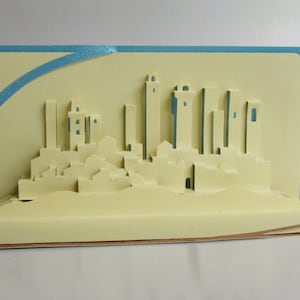 San Gimignano in Italy Pop Up 3D CARD Home Décor Origamic Architecture Hand Cut in Beige on Shimmery Copper and Shimmery Blue. Folds Flat.