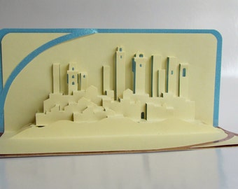 San Gimignano in Italy Pop Up 3D CARD Home Décor Origamic Architecture Hand Cut in Beige on Shimmery Copper and Shimmery Blue. Folds Flat.