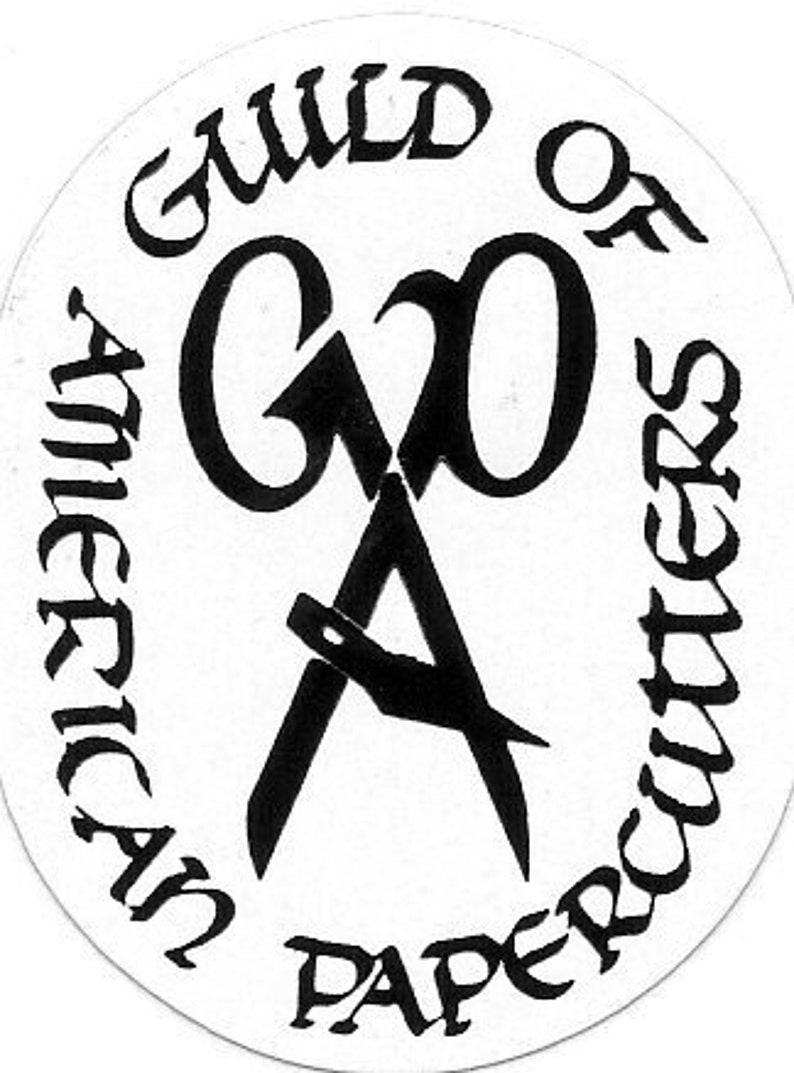 May include: Black and white logo of the Guild of American Paper Cutters. The logo features a stylized pair of scissors with the letters "G" and "O" intertwined.