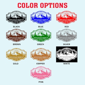 May include: A graphic showcasing various color options for a mountain-themed design. The design features a mountain range, trees, and the text "MOUNTAIN REREAT THE WILLIAM CABIN EST. 2026" in multiple colors, including black, blue, red, brown, green, silver, gold, copper, white, and pink.