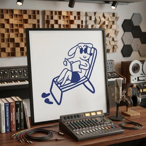 May include: A square framed wall art piece featuring a dark blue line drawing of a cartoon dog wearing sunglasses and sitting in a lounge chair while reading a book. The illustration is centered on a white background within a thin black frame.