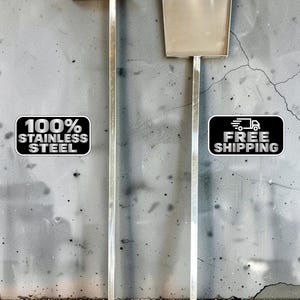 May include: Two stainless steel tools with long, square-profile handles. One tool features a flat, horizontal blade at the top, while the other has a wide, rectangular scoop. Text on the image reads 100% STAINLESS STEEL and FREE SHIPPING.