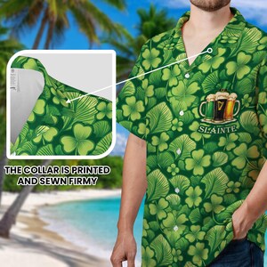 May include: Green button-up shirt with a shamrock and leaf pattern. The shirt features a graphic of three beer mugs with the word "SL&Aacute;INTE". The collar is printed and sewn firmly.