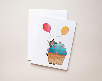 Brown Tabby Cat, Birthday Card - Show some love with a sweet Tabby Cat peeking out from behind a cupcake holding balloons.