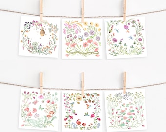 May include: Six square floral art prints are clipped to a string with wooden clothespins. Each print features a watercolor illustration of flowers, bees, butterflies, and dragonflies, arranged in a circular or square frame. The prints are displayed against a white background.