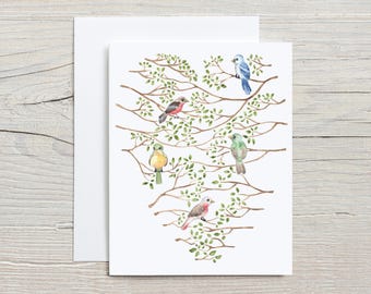 May include: A watercolor greeting card featuring a heart-shaped design of tree branches with green leaves and six colorful birds. The card is accompanied by a white envelope, perfect for sending a heartfelt message.