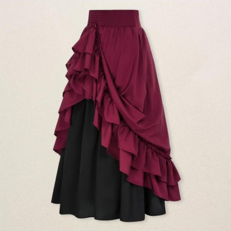 May include: A two-tone skirt with a burgundy ruffled overlay and a black underskirt. The burgundy fabric is draped and gathered, creating a layered effect. The skirt has a high waist and a flowing silhouette, suitable for a costume or special occasion.