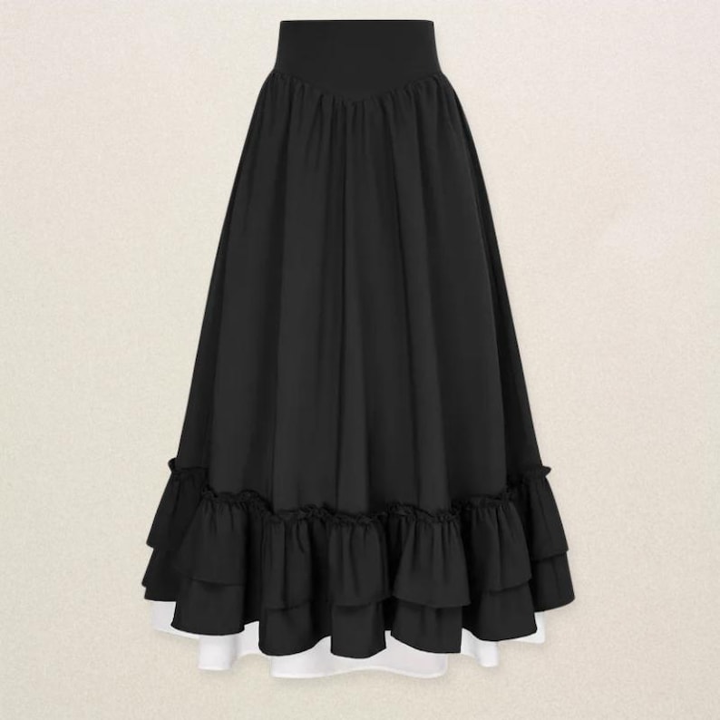 May include: A long, black skirt with a high waist and a layered, ruffled hem. The skirt has a flowing silhouette and a white lining that peeks out from the bottom. The skirt is made of a soft, draping fabric.