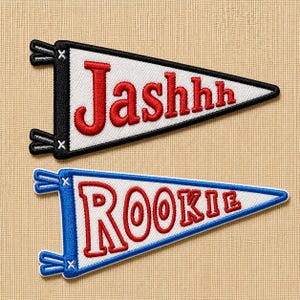 May include: Two embroidered pennant patches. One is black and white with the name "Jashhh" in red. The other is blue and white with the word "Rookie" in red. Both have a triangular shape and are likely for clothing or accessories.