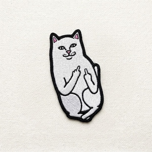 May include: Embroidered patch featuring a white cat with black outlines, pink inner ears, and a pink nose. The cat is giving the middle finger with both paws. The patch is designed to be ironed on or sewn onto fabric.