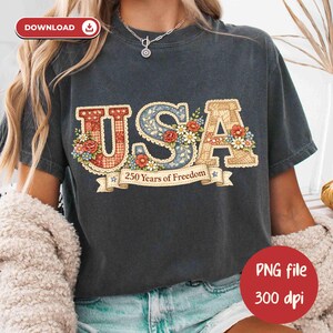 May include: Dark gray t-shirt with the word "USA" in a decorative, floral design. The letters are filled with patterns and flowers, with the text "250 Years of Freedom" on a banner below. A red circle with the text "PNG file 300 dpi" is in the bottom right.